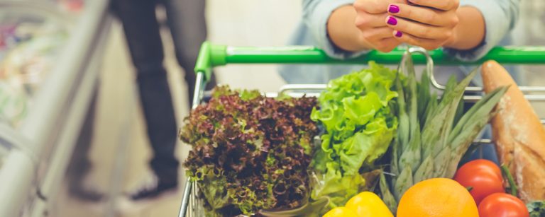 Grocery aisle with bright end-cap deals and eye-level products, highlighting common supermarket tactics like ‘2-for’ offers and strategic placement.