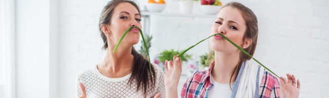 Overhead view of a tidy kitchen counter with chopped vegetables, spice jars, small bowls and labeled meal-prep containers—showcasing simple kitchen hacks.