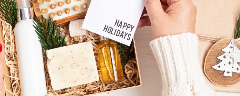 A festive gift setup featuring a yoga mat, healthy cookbook, smoothie maker, and herbal teas wrapped in holiday paper—representing wellness-inspired Christmas gifts.