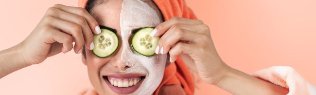 DIY cucumber and mint face mask in a bowl, surrounded by fresh cucumber slices and mint leaves.