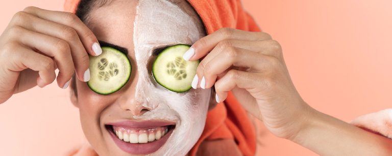 DIY cucumber and mint face mask in a bowl, surrounded by fresh cucumber slices and mint leaves.