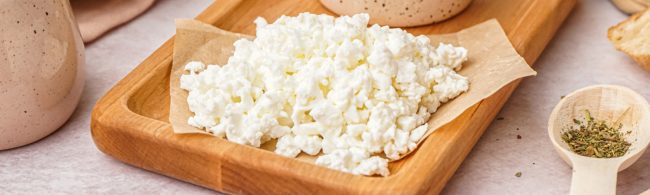 High-protein cottage cheese wrap with greens, cucumber and tomatoes, sliced and ready to eat