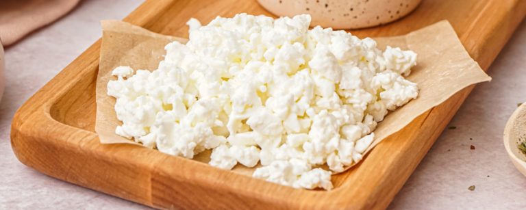 High-protein cottage cheese wrap with greens, cucumber and tomatoes, sliced and ready to eat