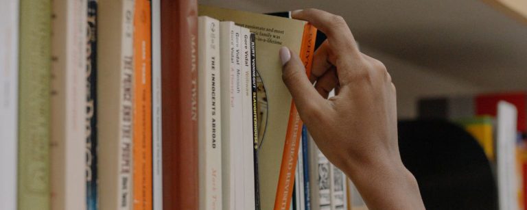 Stack of uplifting self-help books titled to boost your mood, mindset and well-being