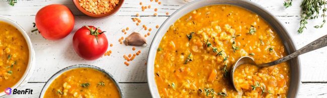 Warm bowl of hearty winter lentil soup with vegetables and herbs