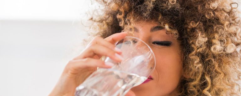 Refreshing glass of water, healthy breakfast bowls and natural energy concept